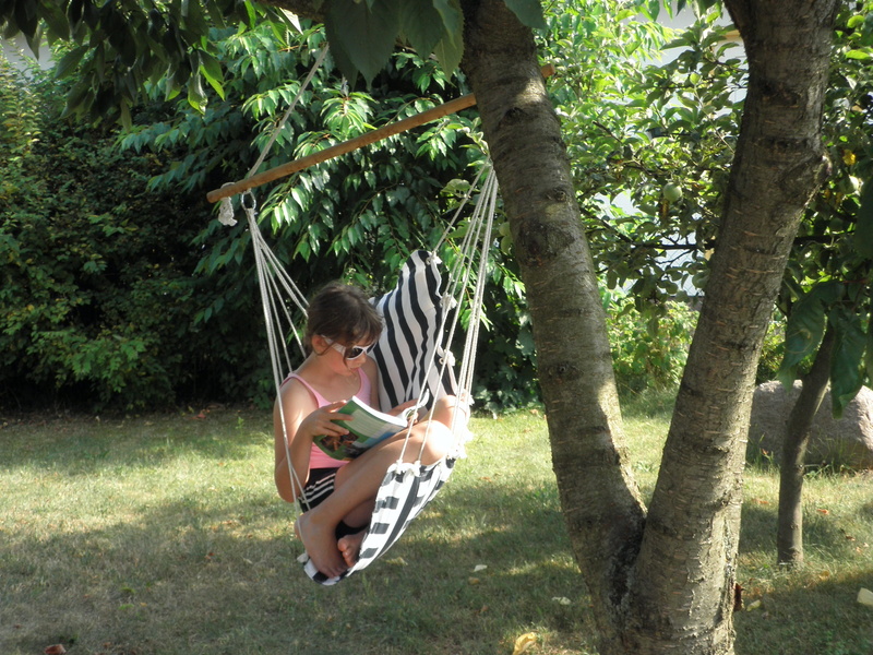 garden, tank top, riding, growth, read, sunlight, hammock, children only, full length, day, girl, pink tank, tank, land, real people, under the tree, one person