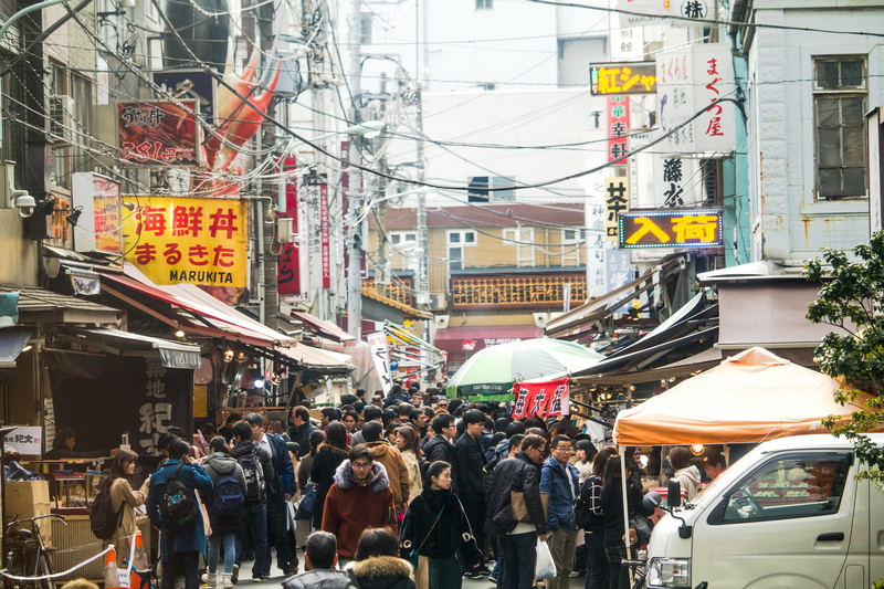 mode of transportation, text, busy, store sign, men, fish, city, crowds, transportation, women, group of people, crowd, building exterior, street, city street