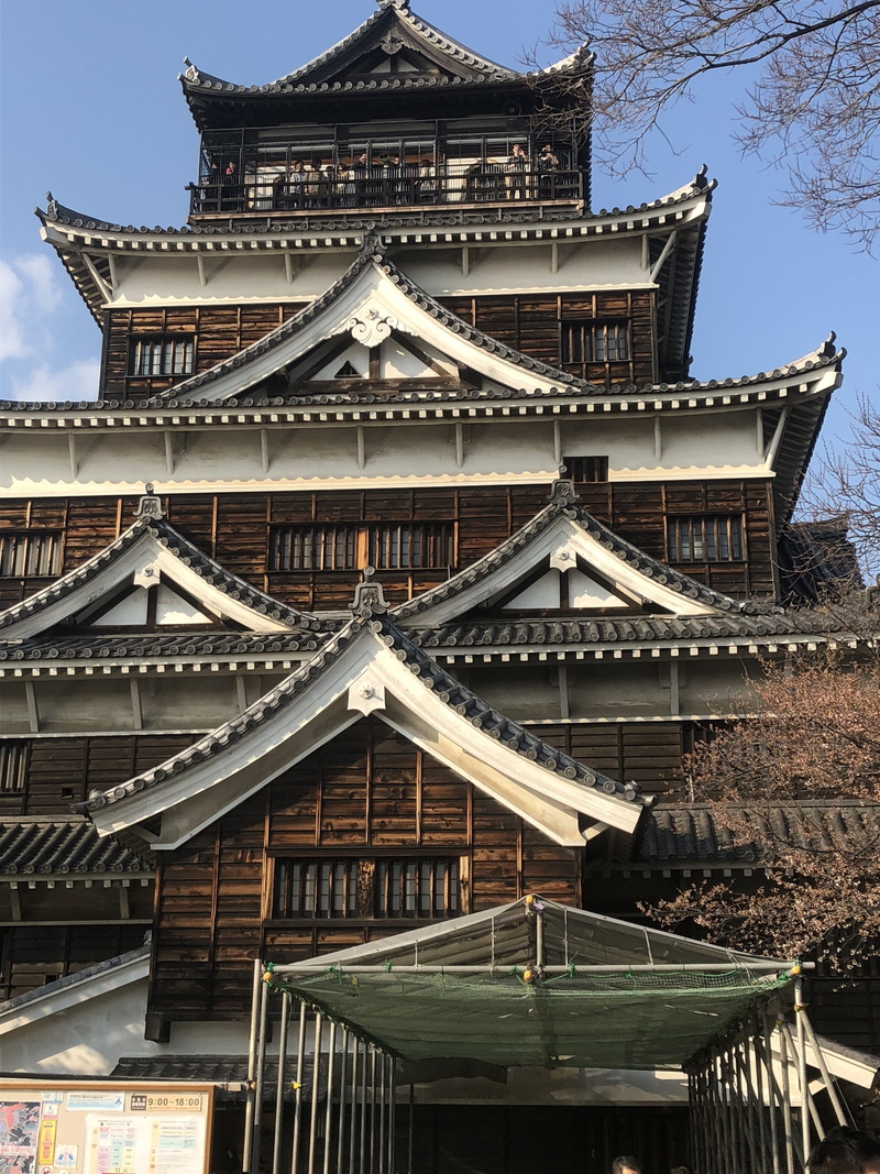 low angle view, tower, architecture, travel destinations, temple, hiroshima castle, built structure, wood, spirituality, building exterior, belief, ancient