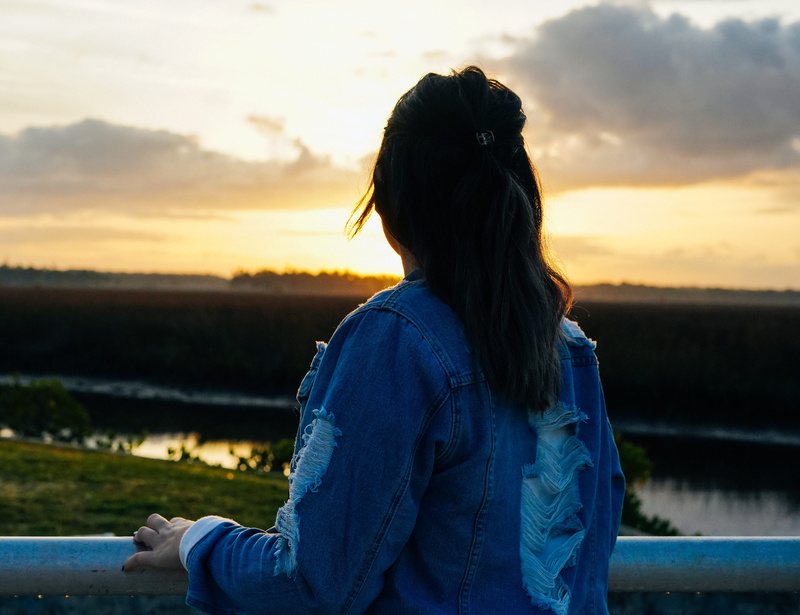 sitting, sunrise, sweater, women, portrait, outdoors, young women, real people, jacket, hairstyle, hair, pants, fl, lifestyles, nature, leisure activity