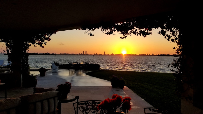 outdoors, ocean, railing, tree, sun, flare, plant, dusk, red sky, dawn, lake, reflection, beauty in nature, miami, patio, orange color, light, water, sunlight