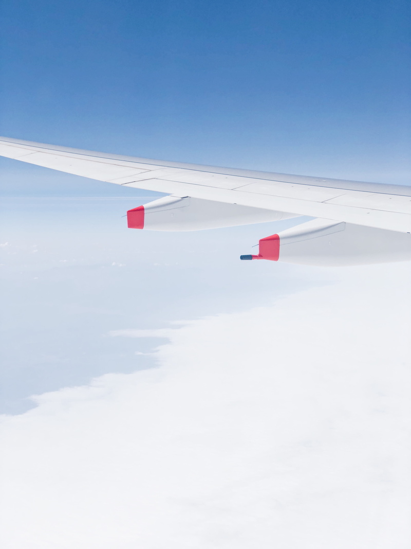 up, white color, scenics - nature, sunlight, wing, outdoors, minimal, cloud - sky, travel, no people, flight, red, nature, copy space, transportation, aircraft wing