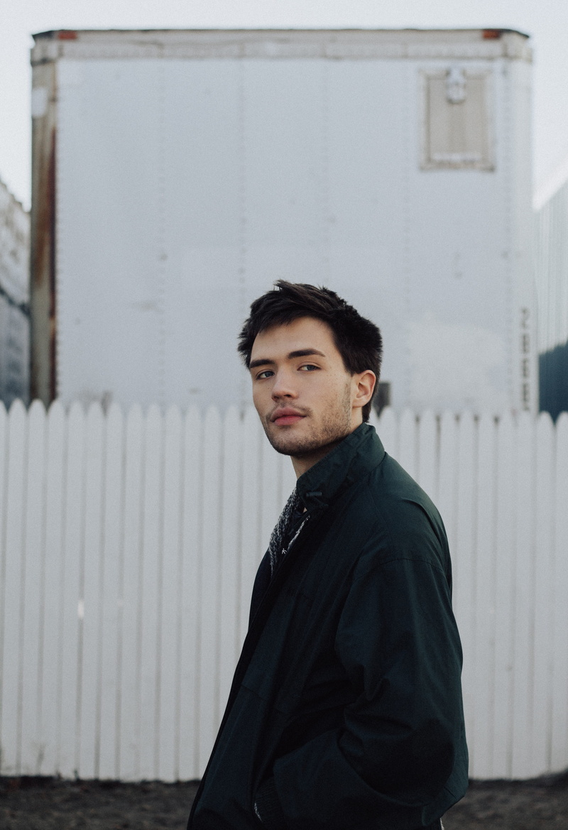 real people, coat, building exterior, fence, portrait, green, masculine, inspiration, jaw, minimal portrait, built structure, near, 4K, one person, blue