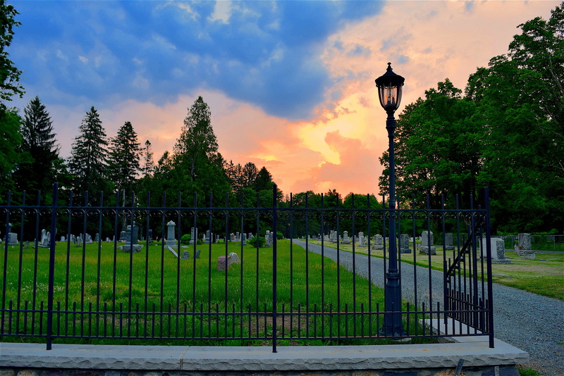 blue, lamppost, in a row, outdoor, green color, landscape, walkway, barrier, sky, cemetery, ominous, orange, grass, green, colorful, trees, dramatic, tranquility