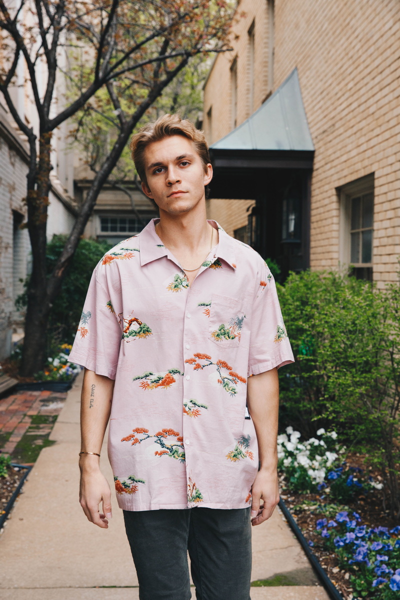 human, vase, plant, building, floral, home decor, button, standing, flagstone, real people, pants, potted plant, one person, apparel, wearing, clothing