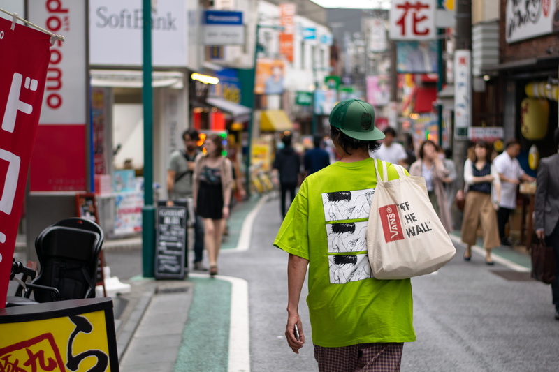 road, daytime, japan, city, focus on foreground, real people, overcast, bokeh, hat, western script, text, outdoors, occupation, incidental people, bag