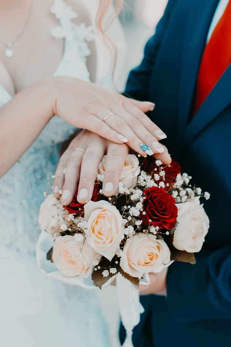 wedding ceremony, bride, ring, marriage, person, flower arrangement, plant, positive emotion, blooming, red, petals, wedding, human hand, white dress, rose - flower