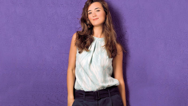 looking at camera, teenager, front view, smiling, brown hair, wall - building feature, long hair, portrait, hair, looking at viewer, fashion, women, standing
