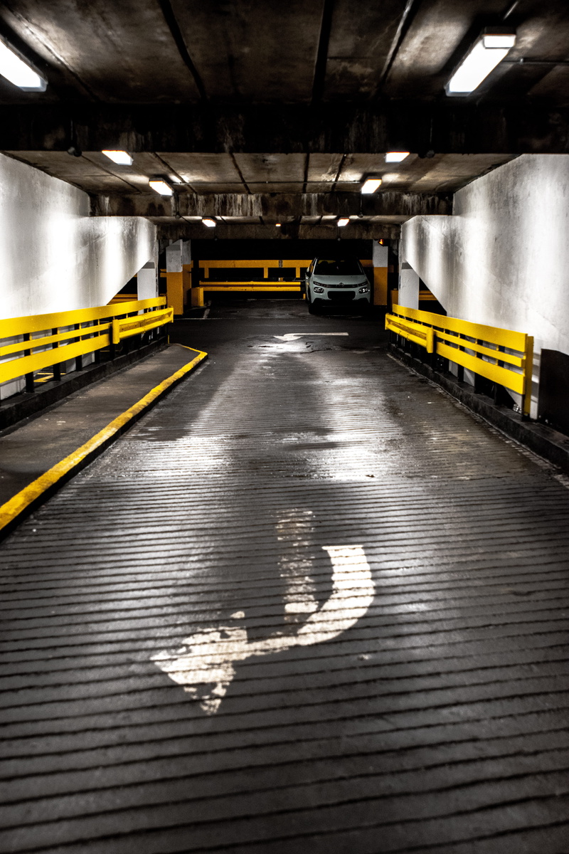 train station, bridge, van, architectural column, car wash, area, subway, room, tunnel, illuminated, no people, sign, boardwalk, subway station, parking meter