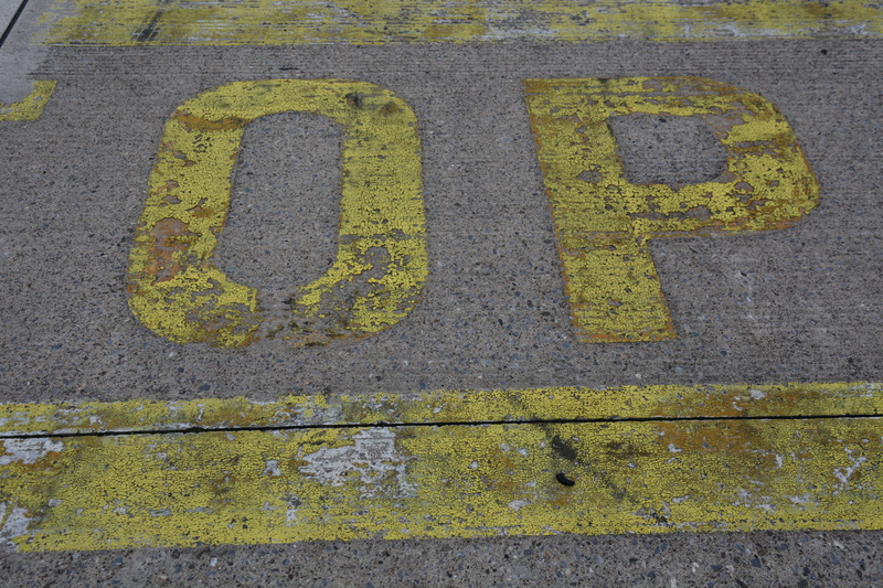 message, close-up, transportation, sign, city, information, communication, airfield, text, number, capital letter, road, taxi, high angle view, street