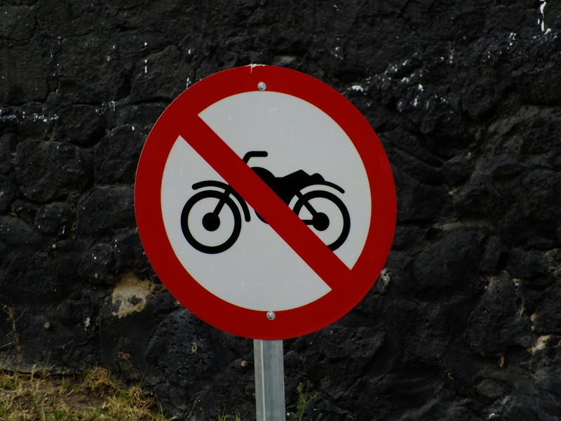 traffic sign, no motorcycles, information sign, warning, road, red sign, outdoors, vehicle, no people, forbidden, guidance, regulation, geometric shape