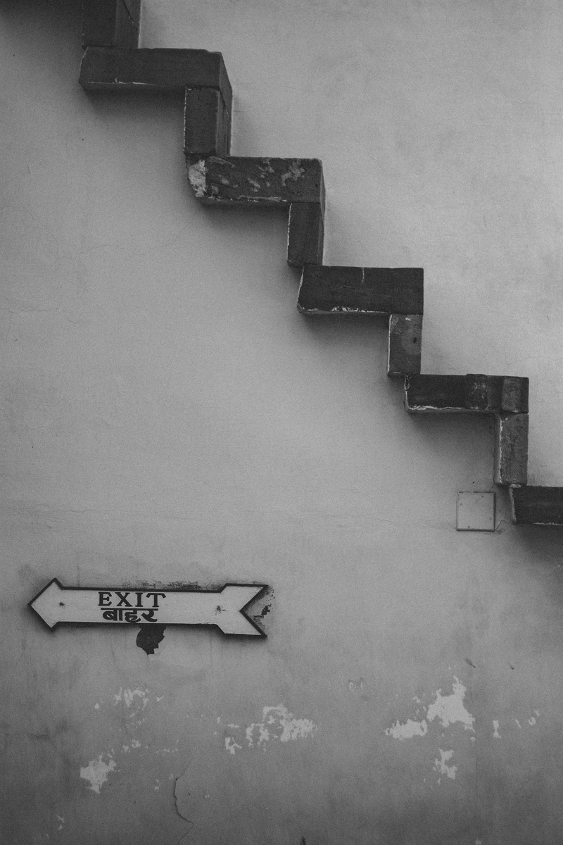 grayscale, wall - building feature, signage, metal, no people, photo, arrow, stairs, day, wood - material, text, brown, exit, absence, upstairs, interior