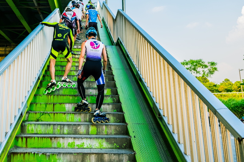 leisure activity, skater, rollerblade, front view, exercise, upstairs, running, railing, staircase, inline, architecture, adult, stair, bridge, full length