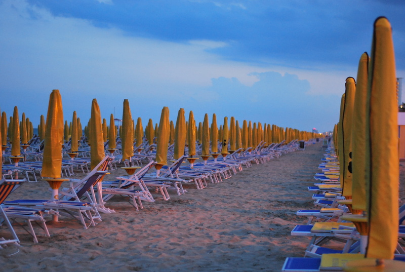 outdoors, lounge chair, land, tranquility, order, in a row, tranquil scene, beach, aisle, word, wood, furniture, horizon over water, water, cloud - sky