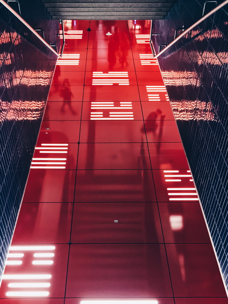 indoors, direction, word, handrail, railing, coat, clothing, built structure, city, tiled floor, architecture, urban, apparel, banister, transportation