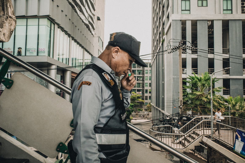 clothing, railing, banister, one person, 5K, shirt, architecture, human, town, outdoors, building, technology, person, fireman, hat, building exterior