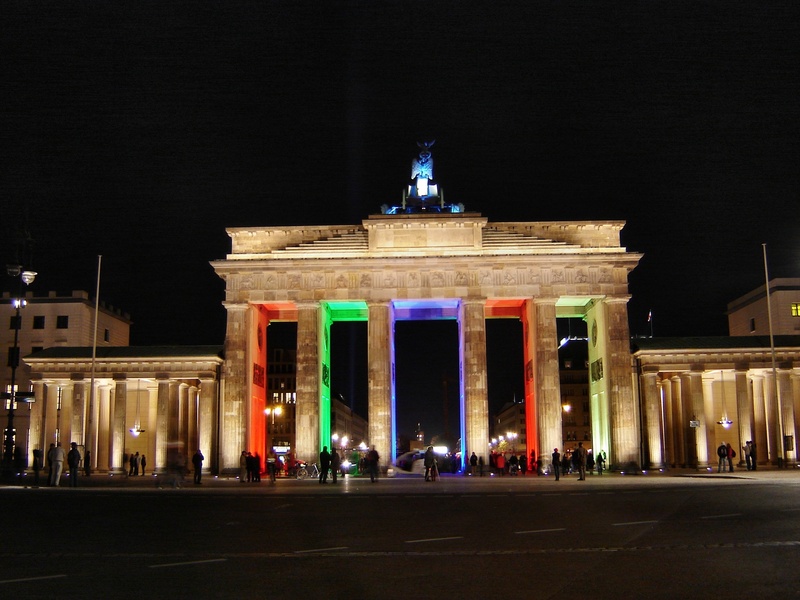travel destinations, the past, building exterior, illuminated, city gate, night, architectural column, crowd, large group of people, city of lights, built structure