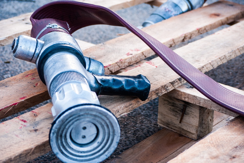 mode of transportation, day, emergency, human body part, men, brigade, transportation, one person, close-up, water, hydrant, wood - material, work tool