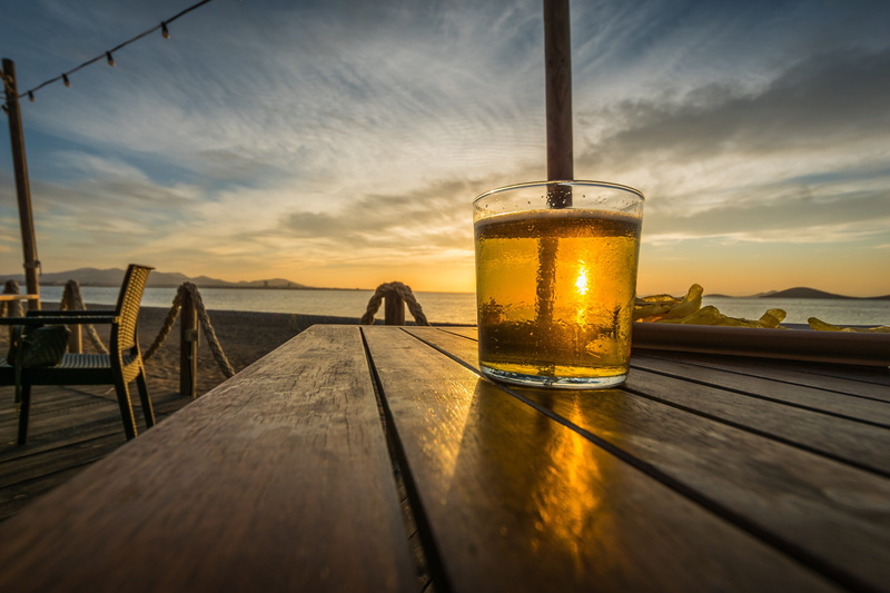 nature, alcohol, sunrise, beach, food and drink, cocktail, drinking glass, cloud - sky, sand, glass - material, water, outdoors, glass, ocean, shore, clouds