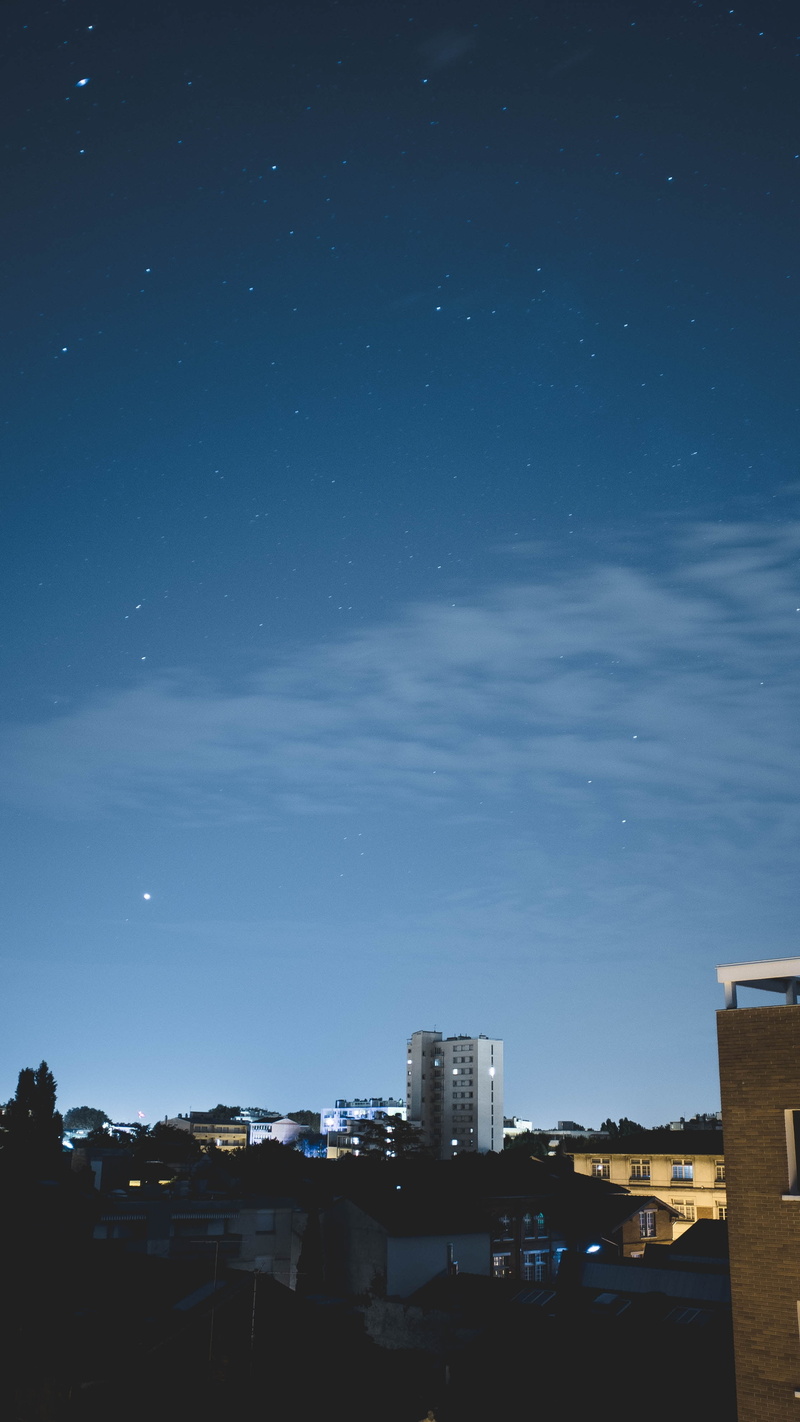 skyscraper, residential district, built structure, sky, starry sky, outdoors, building, nature, architecture, office building exterior, no people, blue