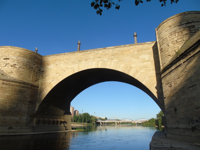 saragossa, bridge - man made structure, arch, arch bridge, sky, nature, building exterior, architecture, blue, day, clear sky, outdoors, ebro, bridge, transportation