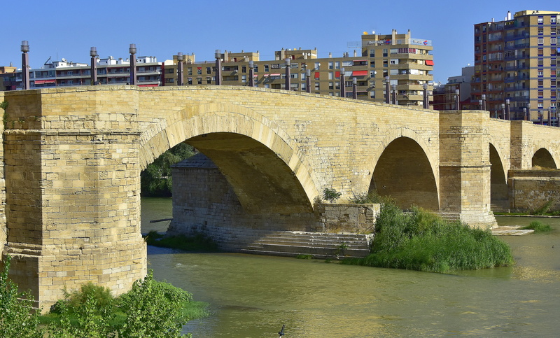 transportation, saragossa, built structure, urban, connection, bridge, sky, arch, clear sky, monument, arch bridge, waterfront, historical, building exterior