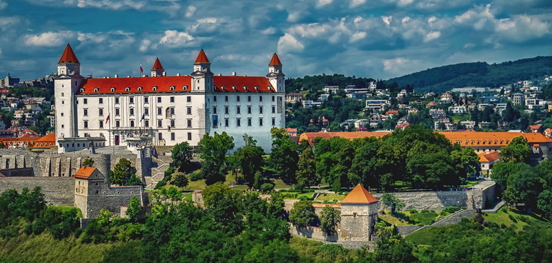 outdoors, city, sky, cityscape, church, castle, built structure, cloud - sky, roof, house, tree, day, tower, bratislava, the past, architecture, plant