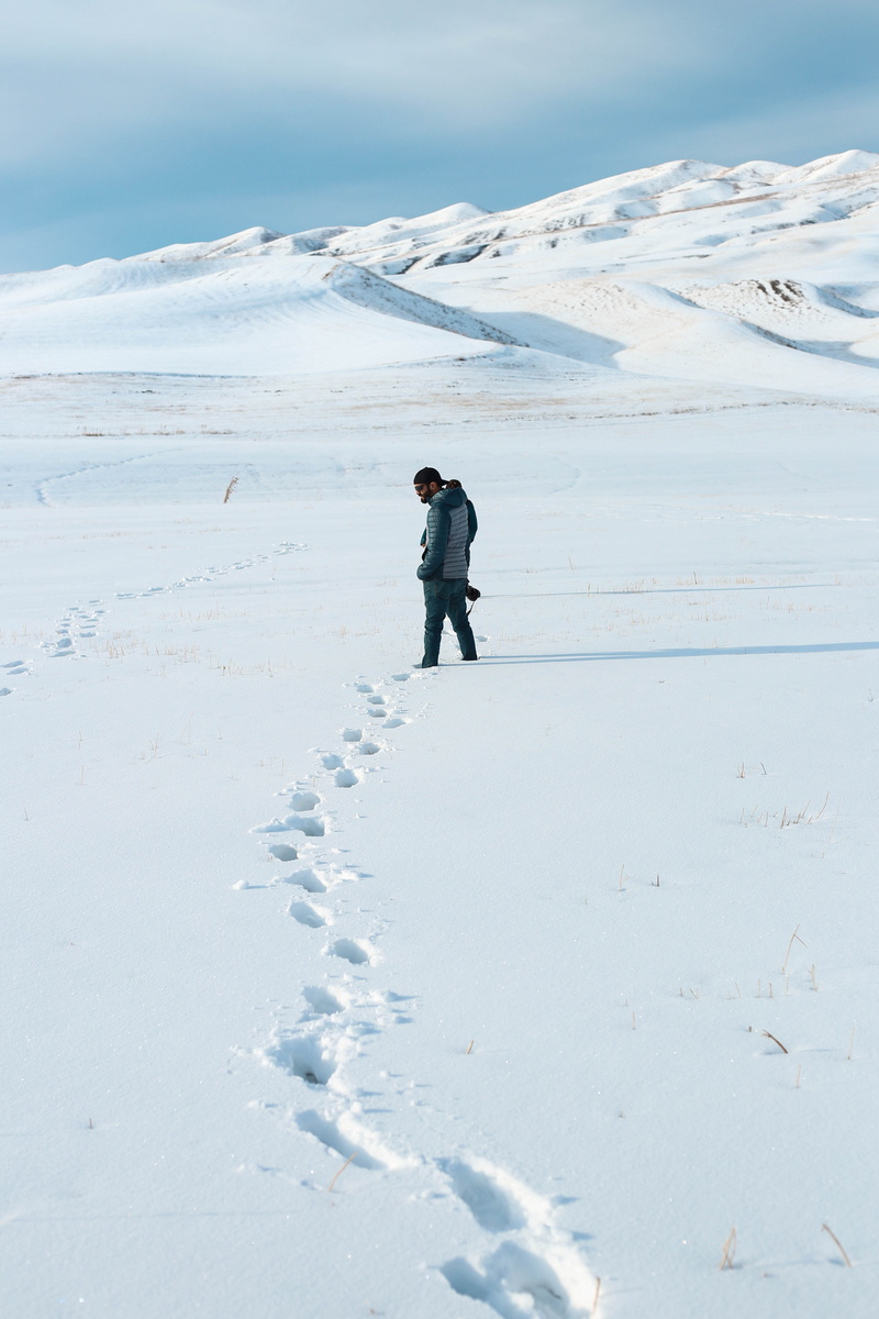 photographer, daylight, man, area, white color, real people, covering, guy, scenics - nature, season, person, men, full length, landscape, explore, tranquility