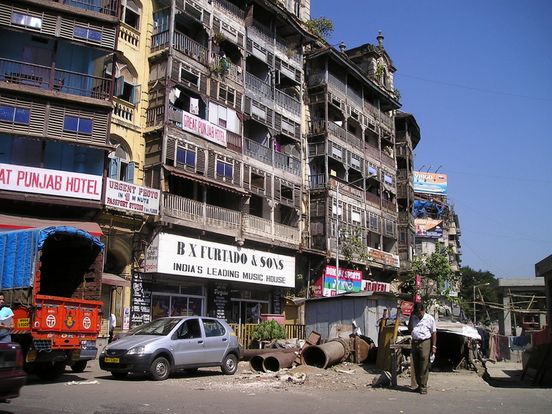road, architecture, city, bombay, motor vehicle, sky, built structure, homes, day, building exterior, nature, group of people, mode of transportation, land vehicle