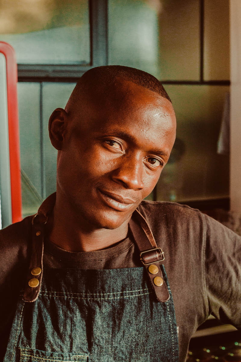 young adult, looking at camera, male, crew, lifestyles, facing, focus on foreground, indoors, front view, taking, real people, brown, headshot, one person