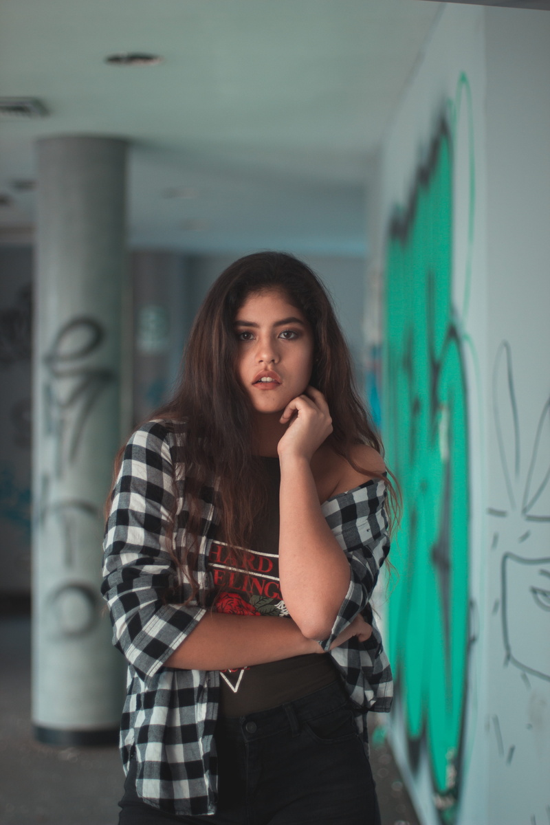 lima region, indoors, casual clothing, peru, adult, hair, real people, long hair, beauty, standing, graffiti, front view, young adult, hairstyle, contemplation