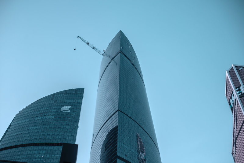sky, blue sky, city, built Structure, office center, window, office building exterior, street, blue, business, glass - material, travel destinations, tall - high