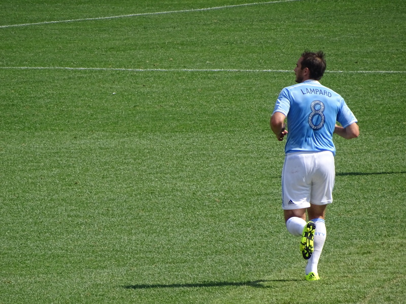ball, day, plant, dress, green color, lifestyles, european, full length, sports clothing, nature, culture, grass, standing, winner, sport, costume, soccer field