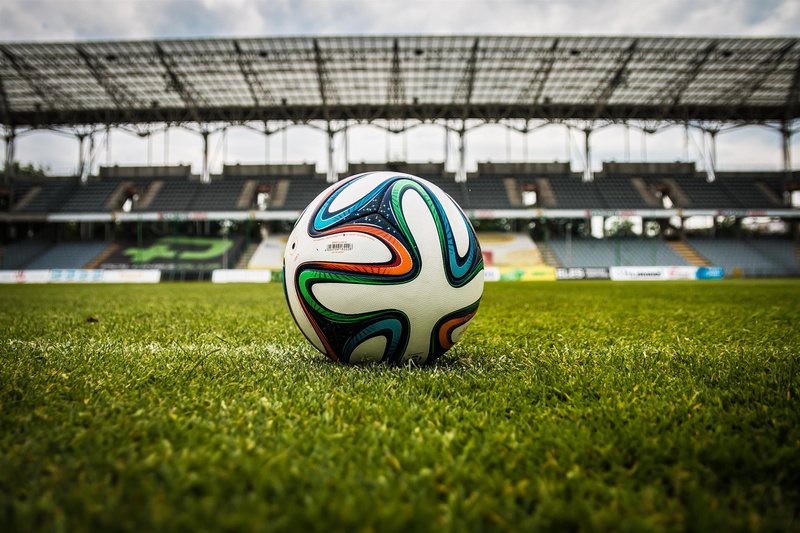 soccer, ball, no people, black, focus on foreground, competition, plant, selective focus, soccer ball, outdoors, day, 2K, white, soccer field, green, grass