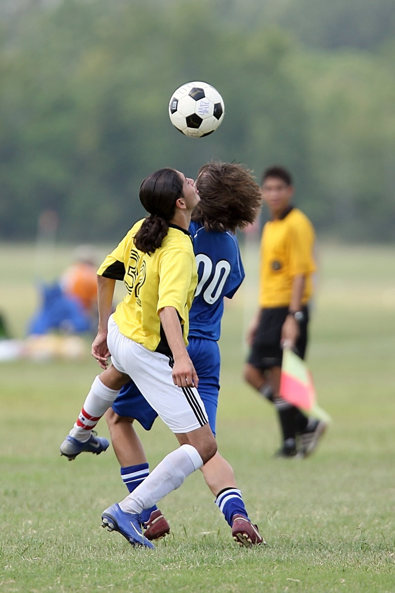 athlete, soccer player, head, outdoors, soccer game, team, players, sports Uniform, referee, skill, teamwork, sports clothing, playing Field, kicking, soccer Ball