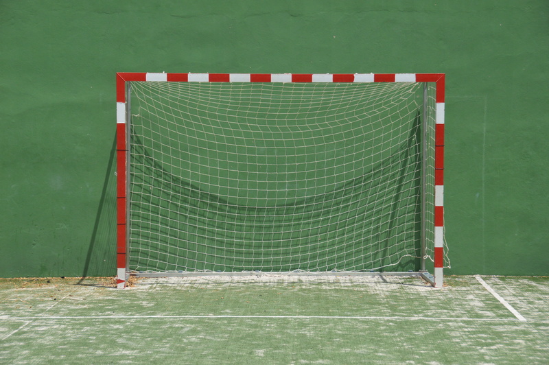 football, sport, competition, soccer, green color, nature, team sport, net, single object, flag, goal, grass, outdoors, sports equipment, striped, game