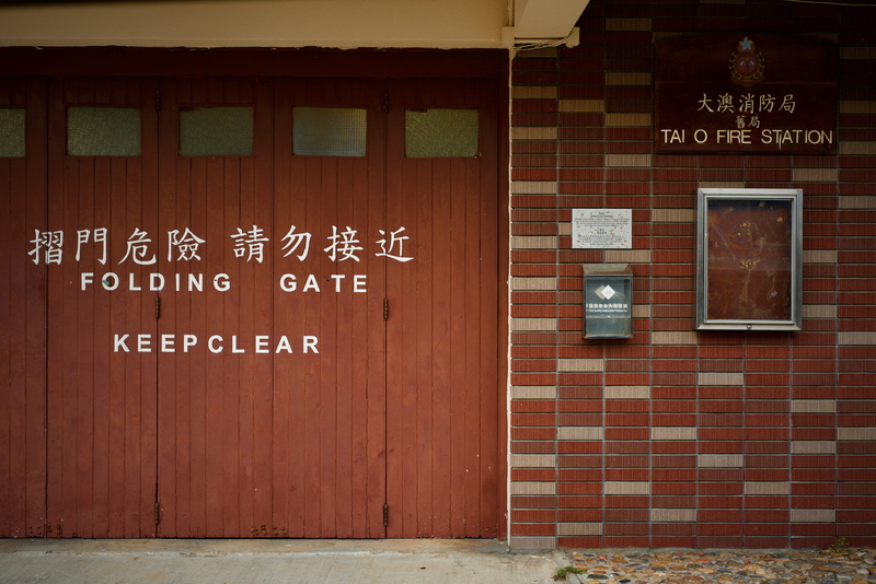 no people, built structure, day, keep clear, brown, building, brick wall, number, entrance, wall - building feature, closed, door, red, script, communication