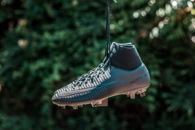 outdoors, boots, animal body part, no people, footballboots, animal head, tree, green color, soccer, animal themes, nike, selective focus, side view, nature