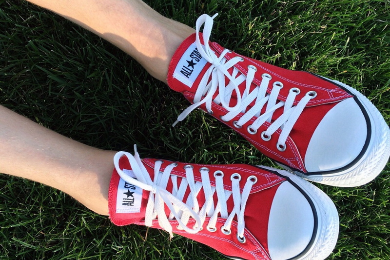 one person, footwear, text, warning sign, red, capital letter, event, western script, human body part, sign, 2K, converse, nature, human limb, plant, high angle view