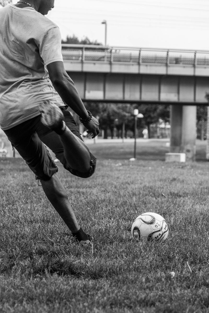 black, male, young, football, plant, men, land, sports equipment, leisure activity, full length, black and white, team sport, one person, goal kick, human