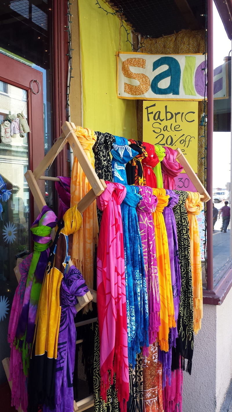 shop, text, pink, design, day, outdoors, no people, variation, scarf, yellow, display, communication, textile, purple, color, large group of objects, fabric