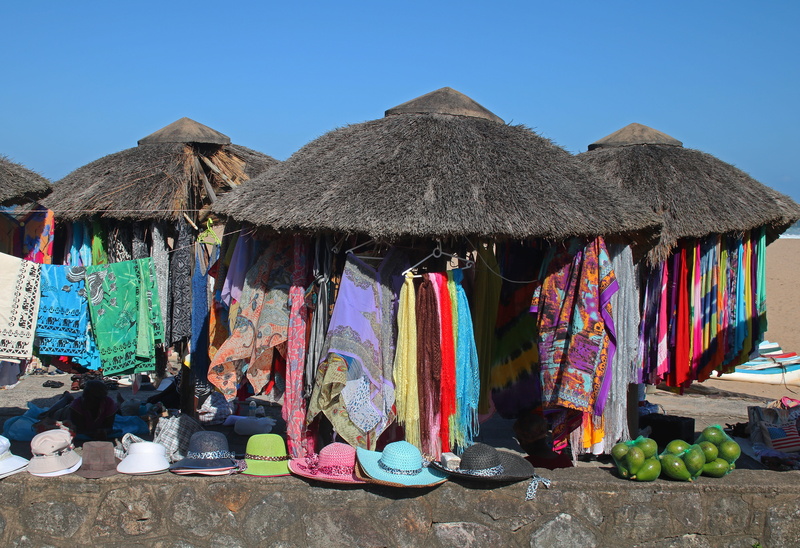 flea market, thatched roof, market, scarves, towels, thatched roofs, street market, large group of objects, architecture, building exterior, 5K, hats