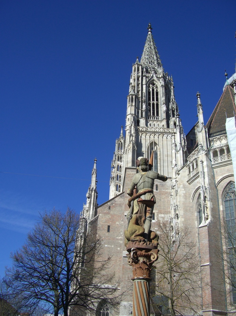 place of worship, sculpture, outdoors, day, tree, spire, low angle view, spirituality, religion, nature, ulm cathedral, built structure, rock carving, gothic