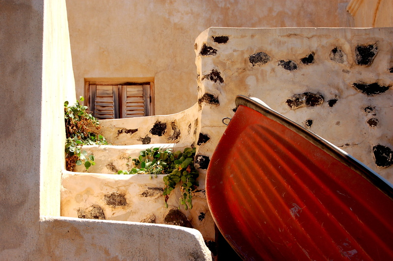 building, built structure, door, greece, day, wall, house, entrance, santorini, window, boat, outdoors, sunlight, oia, residential district, potted plant