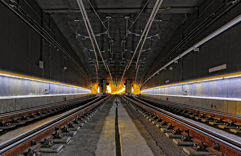 transportation, built structure, railroad station platform, long, diminishing perspective, parallel, outdoors, tunnel, lighting equipment, infrastructure