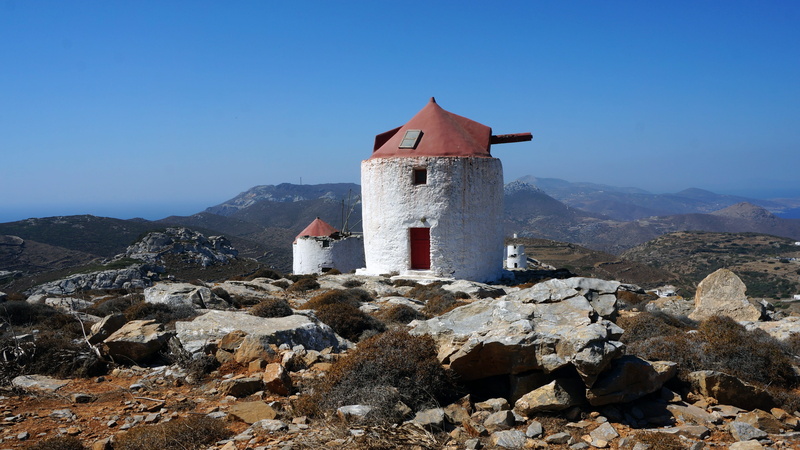rock, Amorgos, house, clear sky, sky, outdoors, architecture, Greece, blue sky, environment, mountain, Island, sun, building exterior, blue, travel, solid