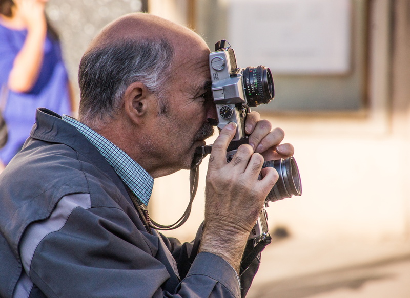 headshot, duplex, real people, side view, vintage, occupation, photo, males, adult, looking through an object, one person, holding, lenses, analog, mature adult