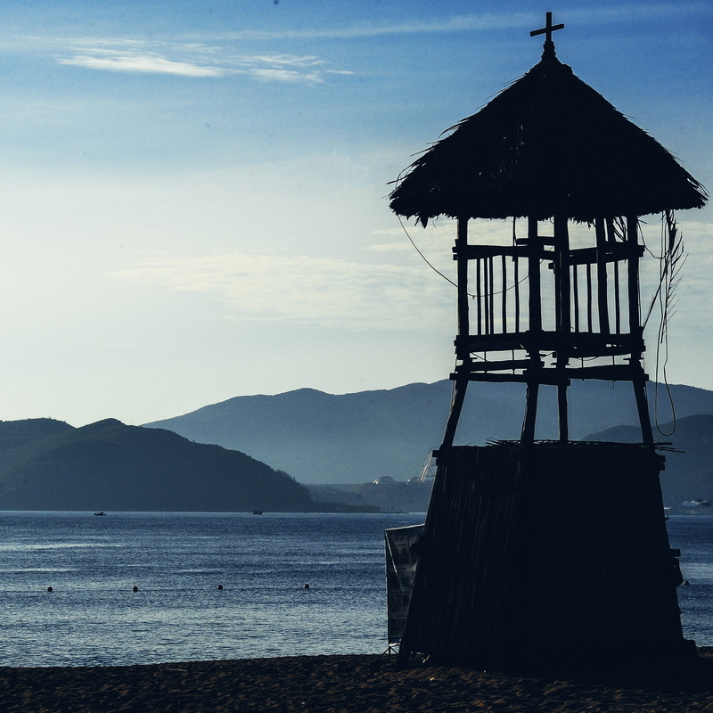 architecture, seashore, landscape, mountain, tower, building exterior, silhouette, scenic, land, beauty in nature, beach, shore, tranquil scene, outdoors