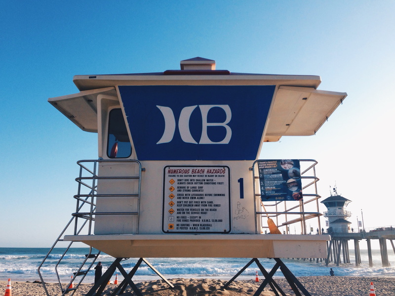 lifeguard hut, sky, text, life guard tower, low angle view, huntington beach, coast, communication, ocean, beach, tower, shoreline, rural, western script