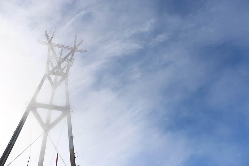 low angle view, sky, architecture, weather, wind turbine, fuel and power generation, turbine, sutro tower, fog, renewable energy, technology, wind power